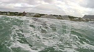 Motor boat entering rough sea on the coast of South Africa