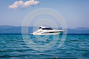 Motor boat floating on clear turquoise water