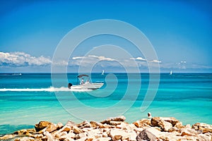 Motor boat floating fast on azure sea water