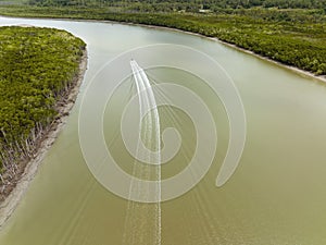 Motor Boat Powering Up A River