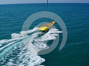 Motor boat sailing fast with parasail parachute. Parasailing boat