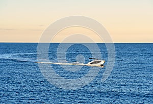 Motor boat in the sea at sunset.Yacht and motorboat on waves in Mediterranean Sea.