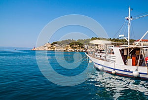 Motor boats parked at pier in Makarska city.