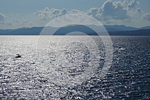 Motor boats sail on the Mediterranean Sea off the coast of Pefki in August. Rhodes Island, Greece