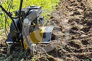 Motor cultivator making fresh raw in garden soil
