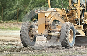 Motor grader machine civil constructionstripping to weed debris in site work. Tractor working in a field for prepared to