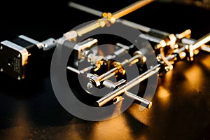 motor and guides for the laser machine. details of the engraving machine, black warm background, orange light photo