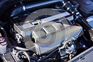 Motor made of carbon elements close up on a sports car