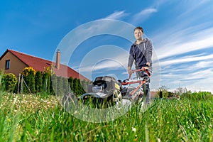Motor mower to mow the lawn next to the family house