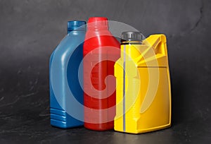 Motor oil in different canisters on black background