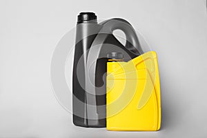 Motor oil in different canisters on light background