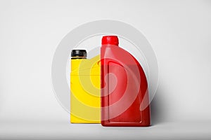Motor oil in different canisters on light background
