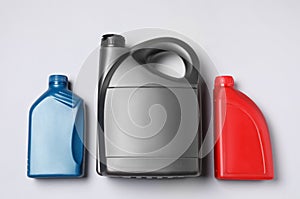 Motor oil in different canisters on light background, flat lay