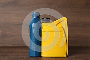 Motor oil in different canisters on wooden background