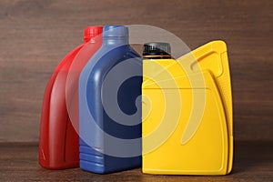 Motor oil in different canisters on wooden background