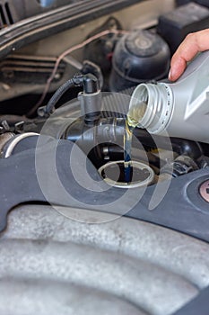 Motor oil pouring to car engine