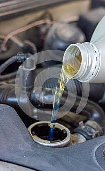 Motor oil pouring to car engine