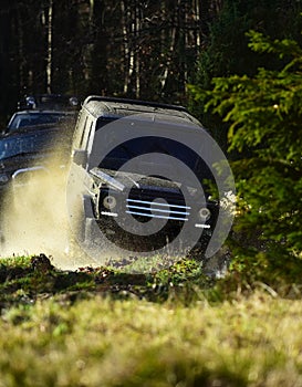 Motor racing in autumn forest. Rallying, competition and four wheel drive concept. Sport utility vehicle or SUV