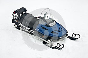 Motor sled at white snow transport