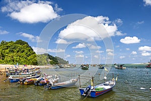 Motor speedboats berthed in a fishing village in the east coast of Malaysia under clear blue skies. photo