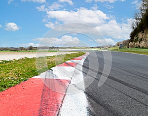 Motor sport asphalt race track and curbs with skid marks