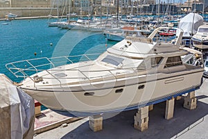 Motor yacht beached at a dock for maintenance and repair
