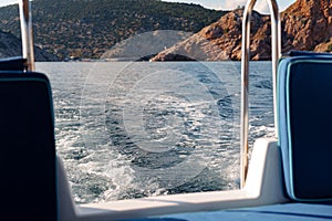 Motor yacht cruising in the sea, view from the stern