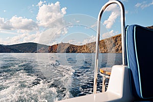 Motor yacht cruising in the sea, view from the stern