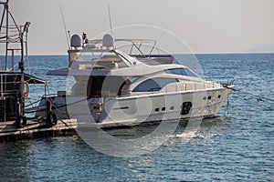 motor yacht moored at a pier on the sea