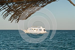 A motor yacht under way on tropical sea