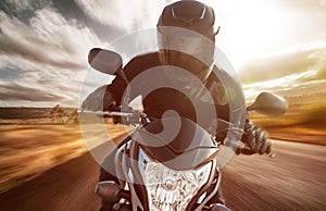 Motorbike on country road at sunset