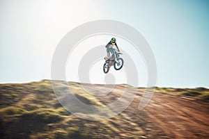 Motorbike, cycling and jump on blue sky mockup for speed challenge, sports and fearless athlete. Driver, air stunt and