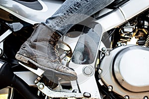 Motorbike details, woman riding on bike.