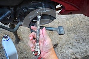 Motorbike Manually Using Wrench for Repairing