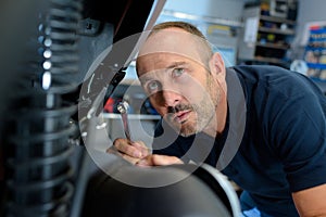 motorbike mechanic checking on spring