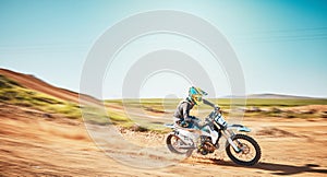 Motorbike, motorsports and speed on dunes with power, sky mockup and offroad path. Driver, motorcycle and travel on dirt photo