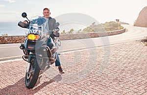 Motorbike, mountain and portrait of man for road, countryside or coastal travel outdoor adventure or sports