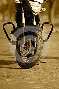 A motorbike is parked on a road - stock photograph