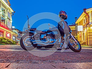 Motorbike is parking on the street of the night city