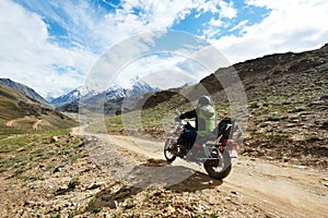 Motorbike tourism. Traveller at motorcycle in mountains