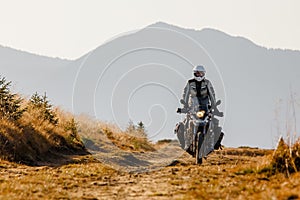 Motorbiker travelling in autumn mountains