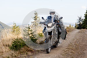 Motorbiker travelling in autumn mountains