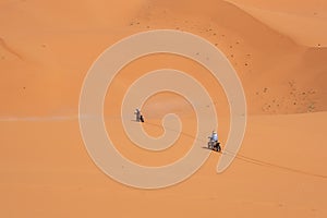 Motorbikers driving off-road in the Erg Chebbi desert near Merzouga