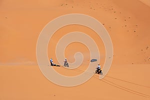 Motorbikers driving off-road in the Erg Chebbi desert near Merzouga