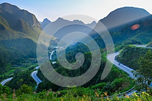 Motorbikers on winding roads through valleys and karst mountain scenery in the North Vietnamese region of Ha Giang / Van