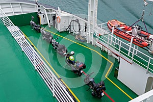 Motorbikes with backpacks at ferry deck photo