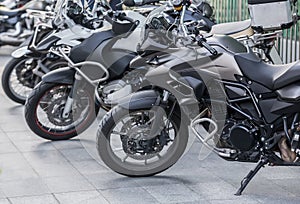 Motorbikes in a parking lot on city street photo