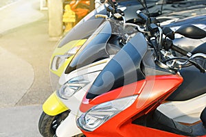 Motorbikes for rent parked in row in city street,