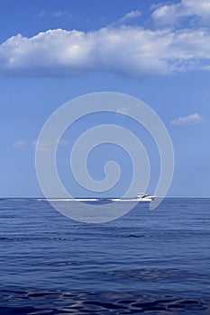 Motorboat fisherboat cruising speed on blue sea