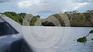 motorboat going down tropcial river in the amazon jungle